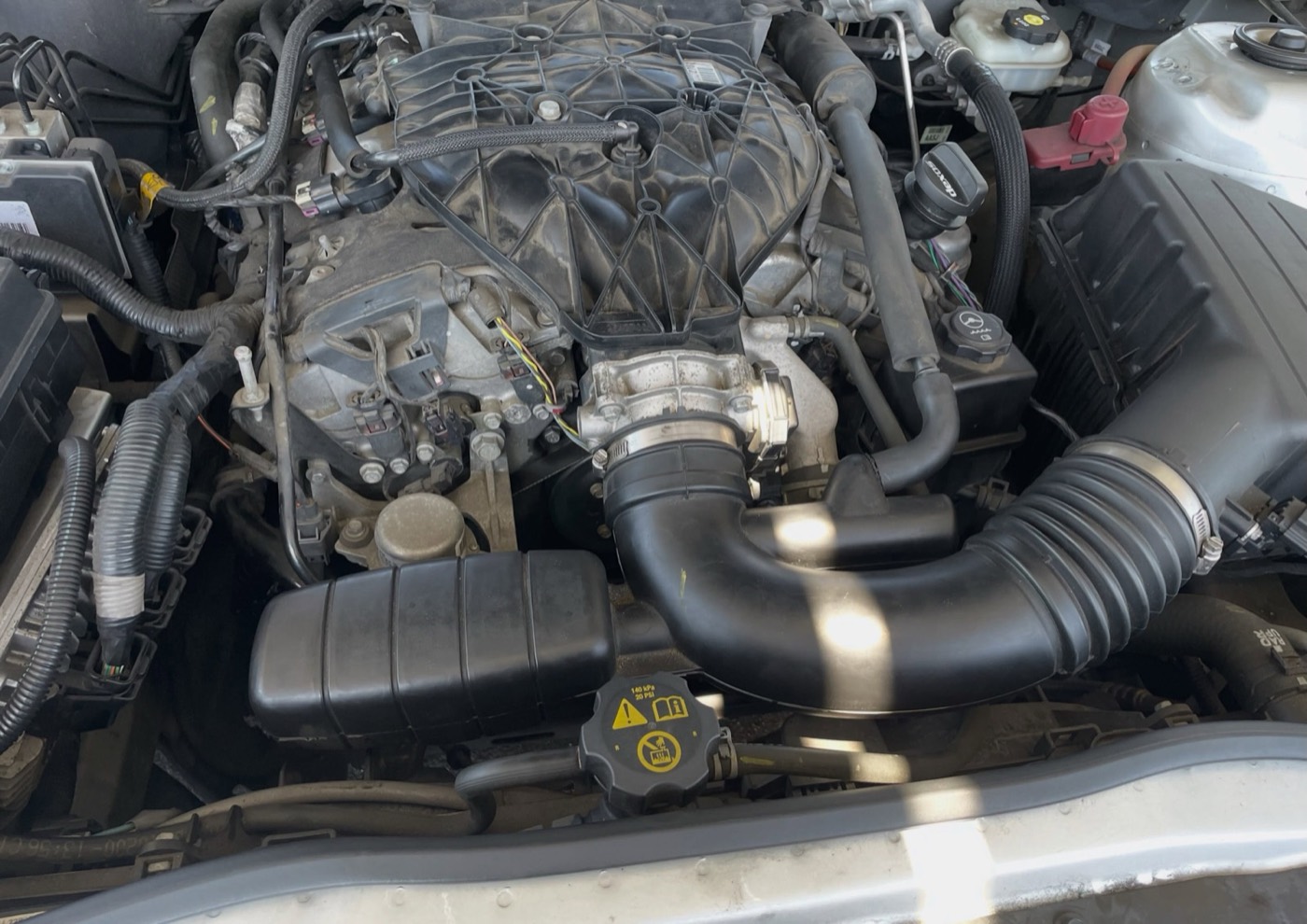 Engine bay of a car after mobile service work