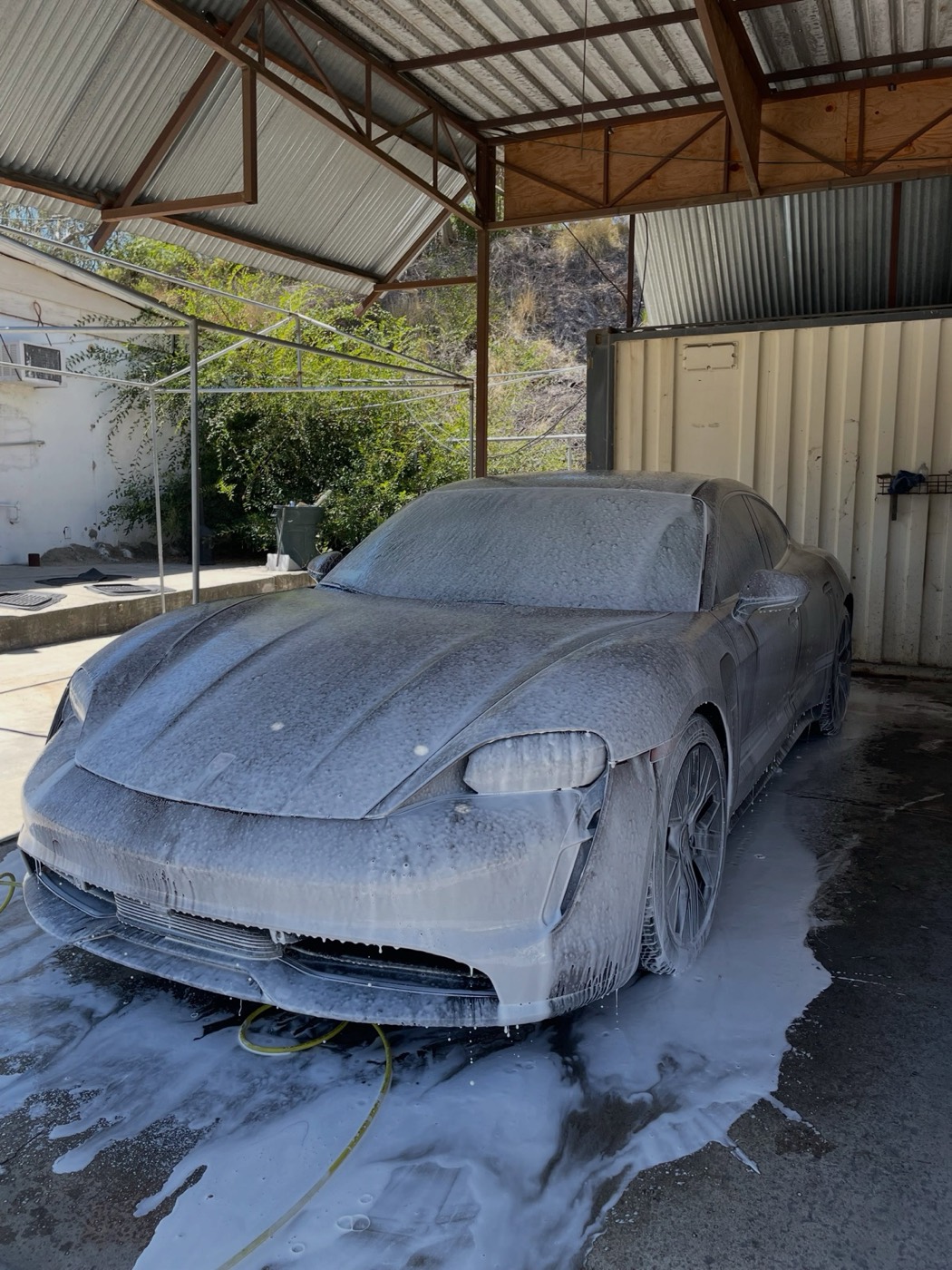 Porsche Taycan covered in foam during a wash